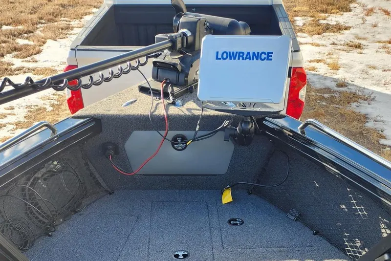 Slide: The Image of 2022 Lund 1975 Tyee Limited boat with Lowrance equipment, parked near a snowy field. - 11
