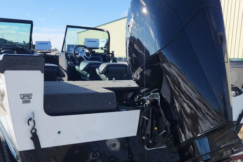 Slide: The Image of 2022 Lund 1975 Tyee Limited boat with powerful outboard motor, featuring dual Lowrance displays. - 7