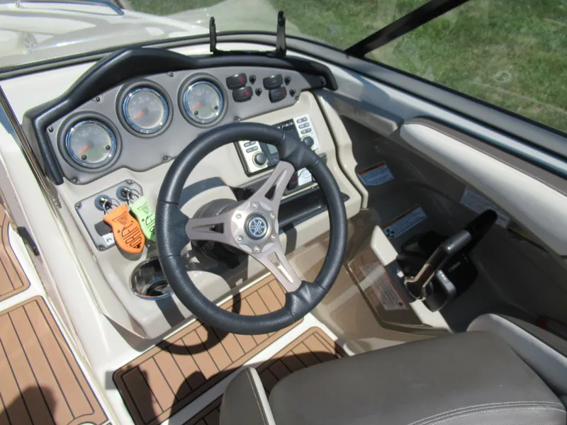 Slide: The Image of 2014 Yamaha Boats 242 Limited dashboard with steering wheel and controls. - 12