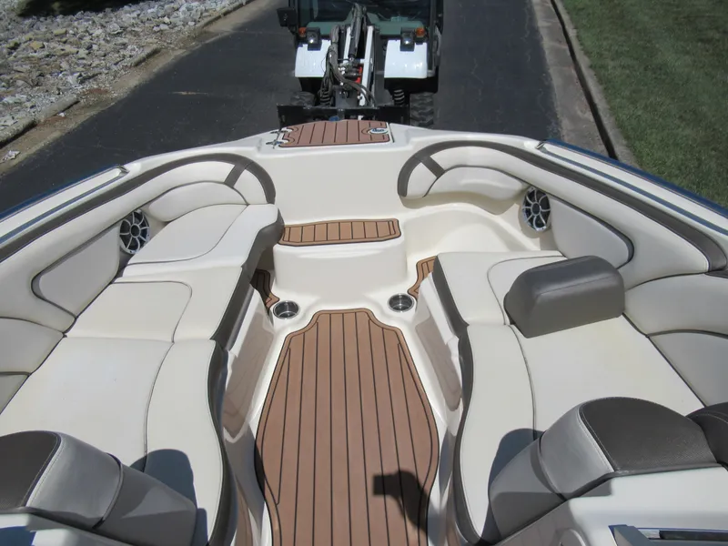 Slide: The Image of 2014 Yamaha Boats 242 Limited interior with beige seating and wood accents. - 18