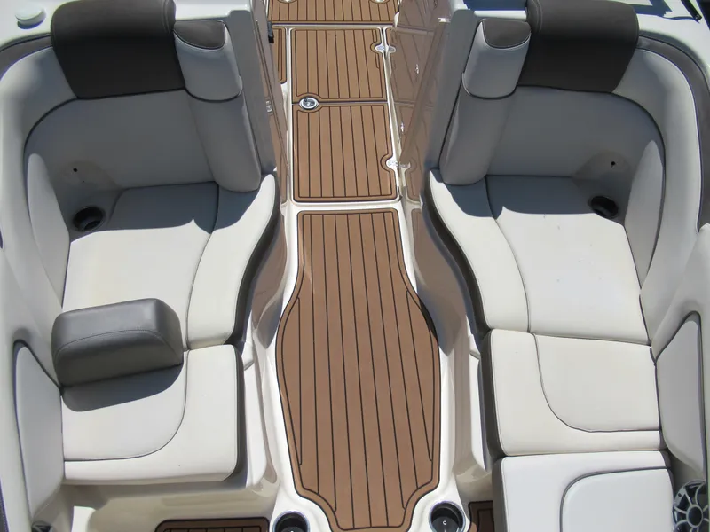 Slide: The Image of 2014 Yamaha Boats 242 Limited interior seating with brown deck flooring. - 20