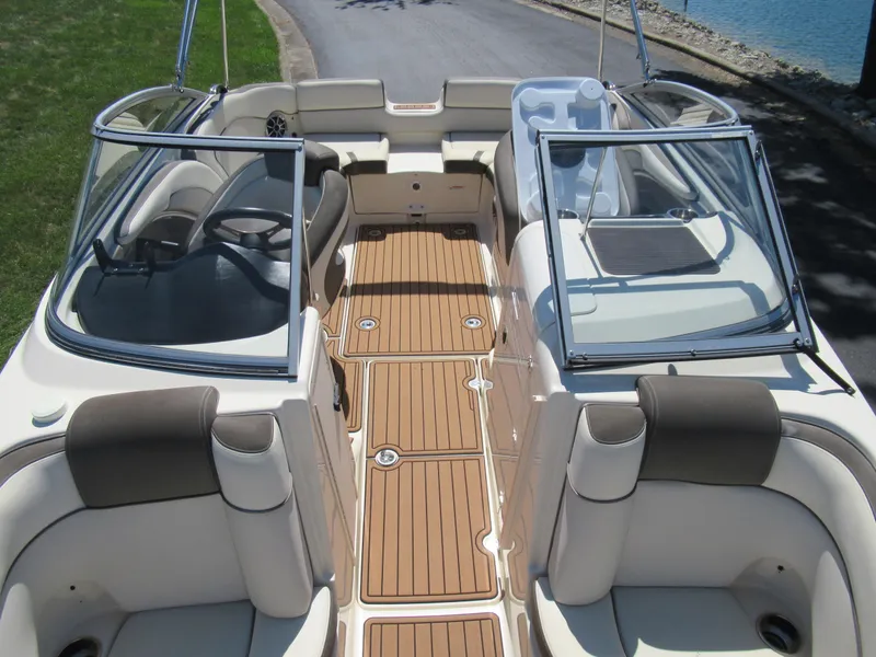 Slide: The Image of 2014 Yamaha Boats 242 Limited interior with tan seating and wood-style flooring. - 21