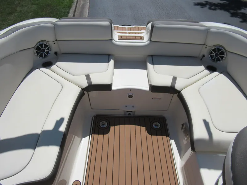 Slide: The Image of 2014 Yamaha Boats 242 Limited interior with beige seating and teak flooring. - 24