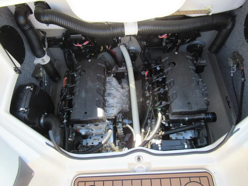 Slide: The Image of 2014 Yamaha Boats 242 Limited engine compartment with dual engines and hoses. - 26