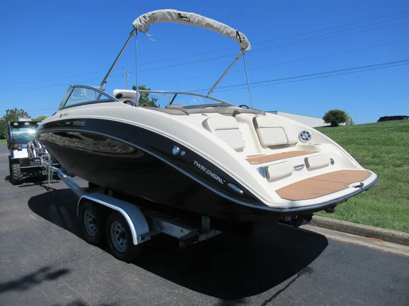 Slide: The Image of 2014 Yamaha Boats 242 Limited on trailer, sleek design, sunny day, parked outdoors. - 3