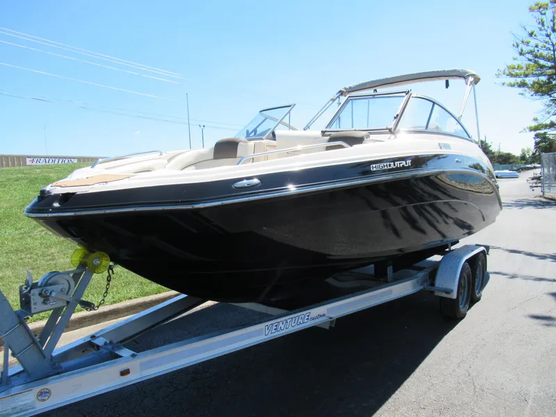 Slide: The Image of 2014 Yamaha Boats 242 Limited on trailer, sleek design, parked outdoors. - 5