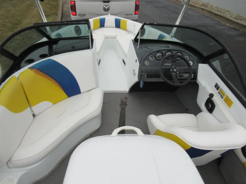Slide: The Image of 2000 Moomba Outback LS boat interior with white, blue, and yellow seating. - 11