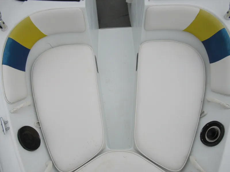 Slide: The Image of 2000 Moomba Outback LS boat interior with white cushioned seating and colorful accents. - 18