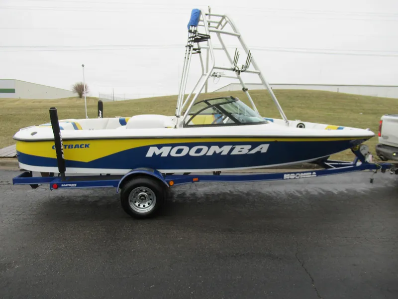 Slide: The Image of 2000 Moomba Outback LS boat on trailer, blue and yellow design, side view. - 4