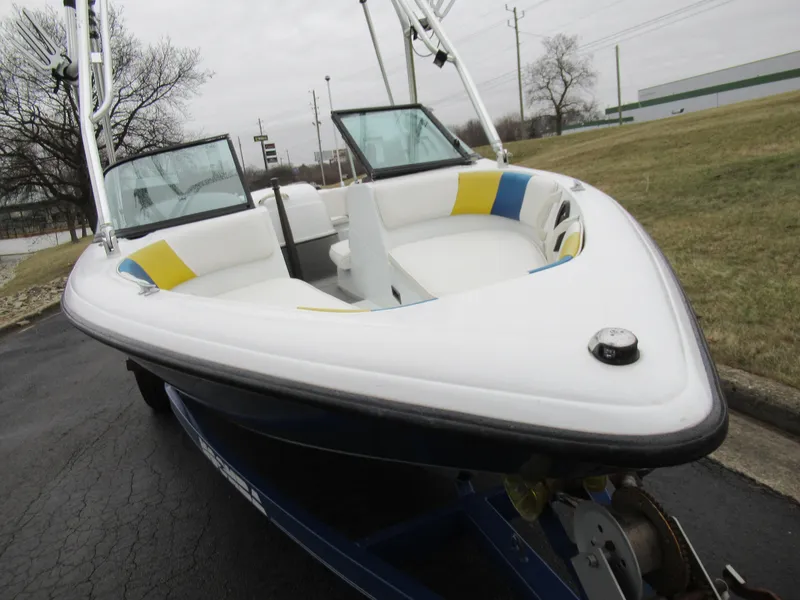 Slide: The Image of 2000 Moomba Outback LS boat with white and blue interior on a trailer. - 6