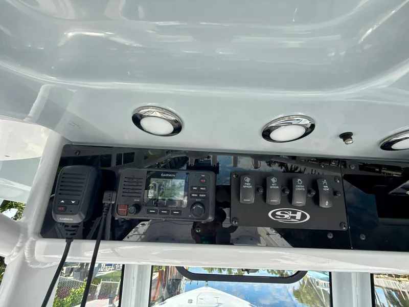 Slide: The Image of 2024 Sea Hunt Ultra 275 SE dashboard with controls and radio equipment. - 15