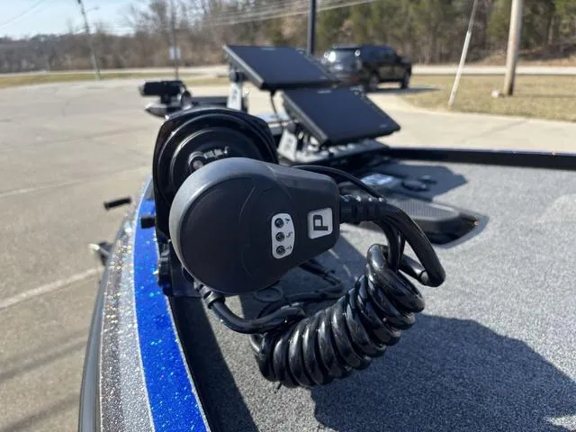 Slide: The Image of 2024 Ranger Z520R bass boat with advanced fishing equipment, parked outdoors. - 10