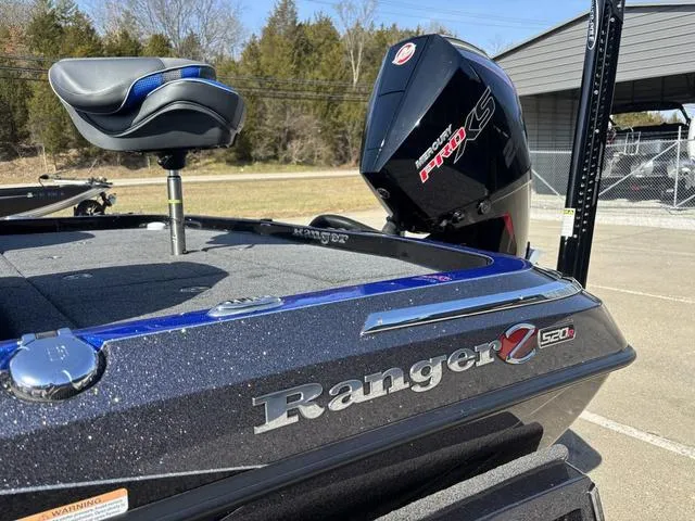 Slide: The Image of 2024 Ranger Z520R boat on trailer, parked outdoors, side view. - 15