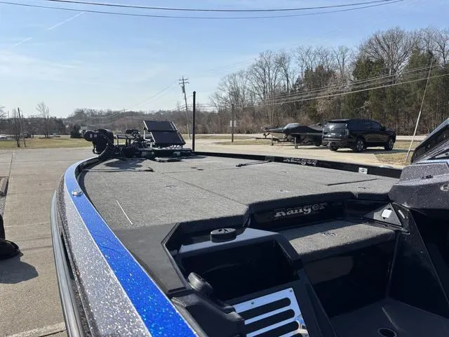 Slide: The Image of 2024 Ranger Z520R boat with spacious deck, parked outdoors on a sunny day. - 17