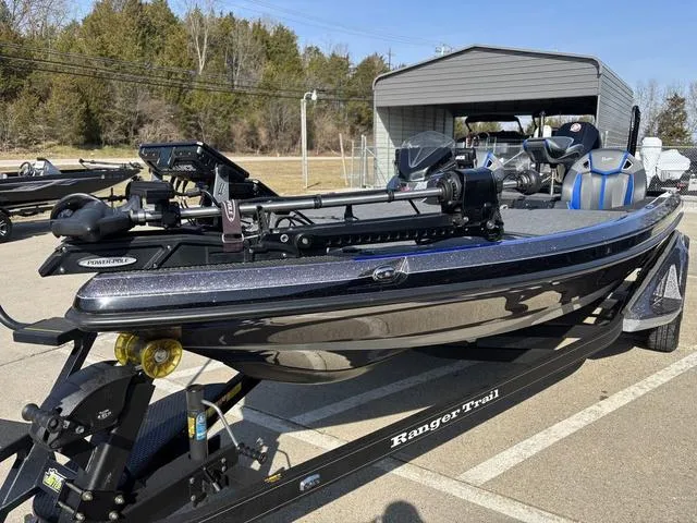 Slide: The Image of 2024 Ranger Z520R boat on trailer outside Nida's Marine dealership. - 9