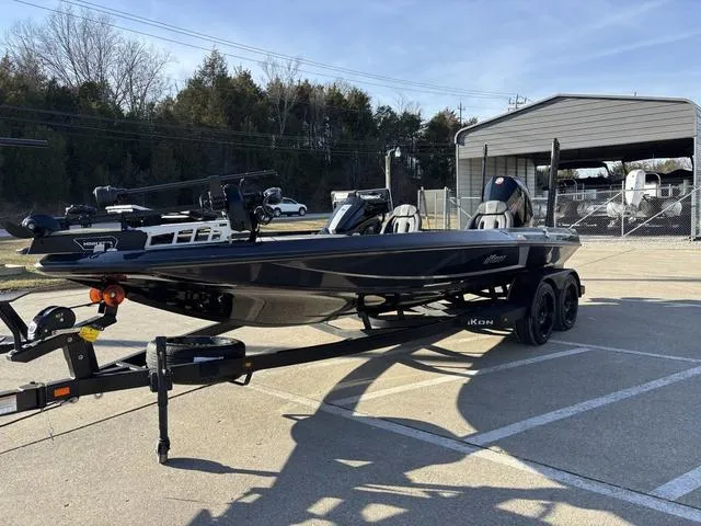 Slide: The Image of 2024 iKon LX20 boat on trailer in parking lot, ready for transport. - 13