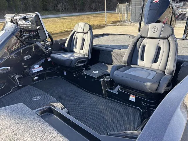Slide: The Image of 2024 iKon LX20 boat interior with two gray seats and a Lowrance navigation system. - 14