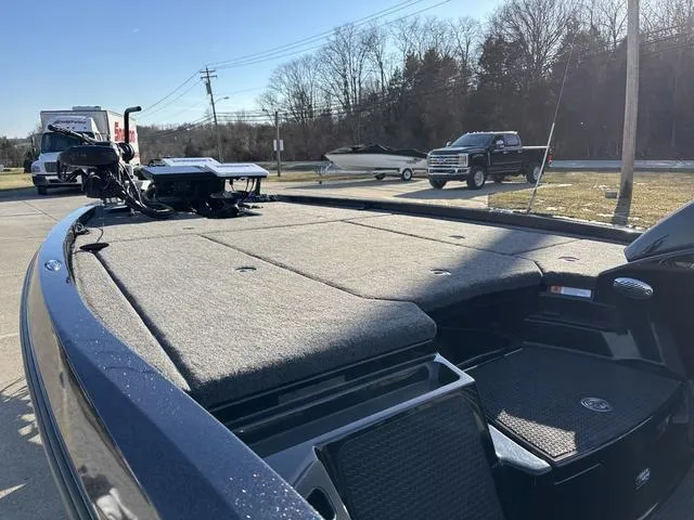 Slide: The Image of 2024 iKon LX20 boat with spacious deck, parked outdoors on a sunny day. - 15