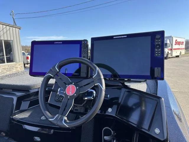 Slide: The Image of Steering wheel and dual navigation screens on 2024 iKon LX20 boat dashboard. - 6
