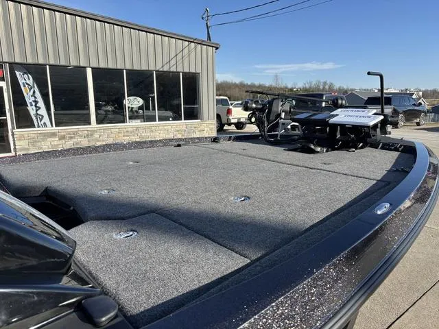 Slide: The Image of 2024 iKon LX20 boat with spacious deck, parked outside a showroom. - 8