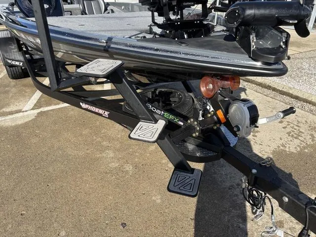 Slide: The Image of 2024 Phoenix 921 Elite II boat trailer with step pads and winch in parking lot. - 11