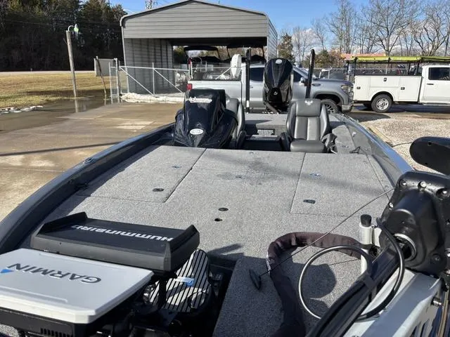 Slide: The Image of 2024 Phoenix 921 Elite II boat with Garmin and Humminbird equipment, parked outdoors. - 14
