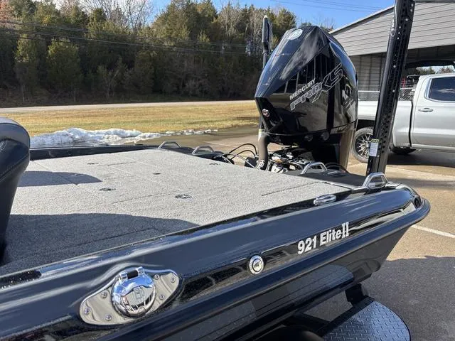 Slide: The Image of 2024 Phoenix 921 Elite II boat with Mercury engine, parked outdoors. - 16