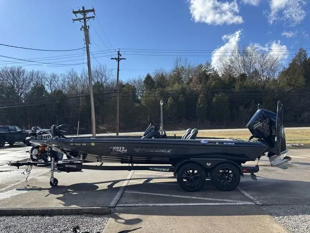 Slide: The Image of 2024 Phoenix 921 Elite II boat on trailer, parked outdoors under a clear sky. - 17