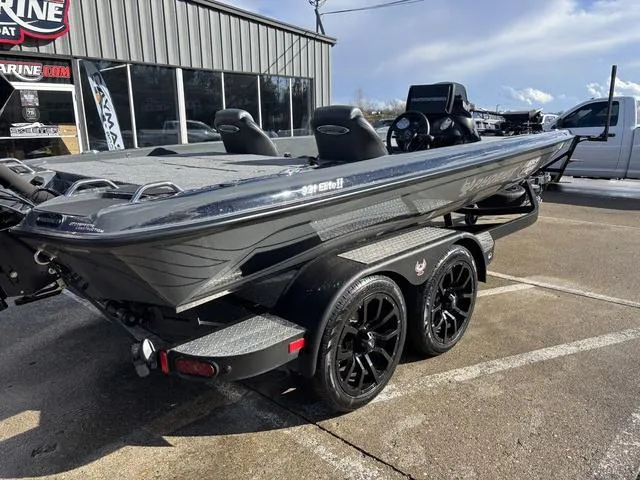 Slide: The Image of 2024 Phoenix 921 Elite II boat on trailer, parked outside a marine dealership. - 4