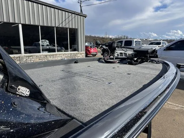 Slide: The Image of 2024 Phoenix 921 Elite II boat on display outside dealership, showcasing spacious deck. - 8