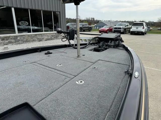 Slide: The Image of 2023 Phoenix 721 Pro XP boat deck with fishing equipment, parked outside a showroom. - 11