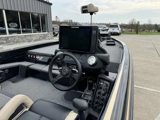 Slide: The Image of 2023 Phoenix 721 Pro XP boat interior with steering wheel and navigation system. - 7