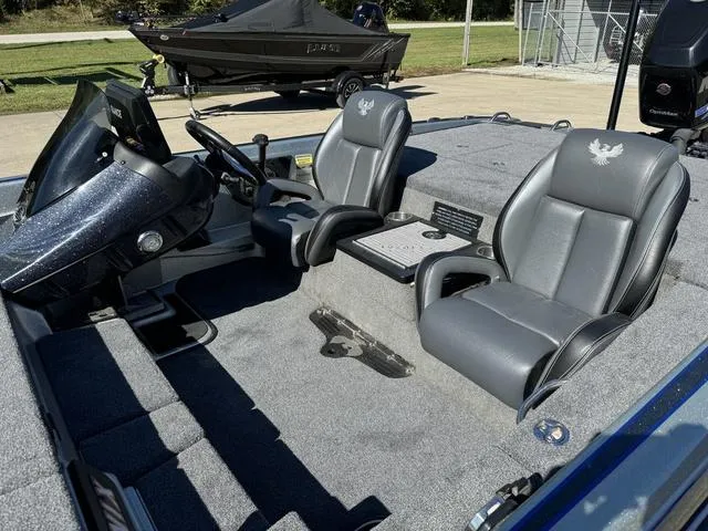 Slide: The Image of 2017 Phoenix 921 PRO XP boat interior with dual gray seats and steering console. - 14