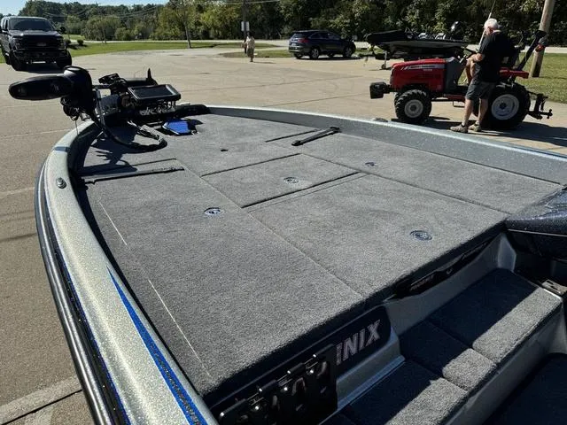 Slide: The Image of 2017 Phoenix 921 PRO XP boat with spacious deck in a parking area. - 16