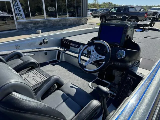 Slide: The Image of 2017 Phoenix 921 PRO XP boat interior with steering wheel and navigation system. - 5