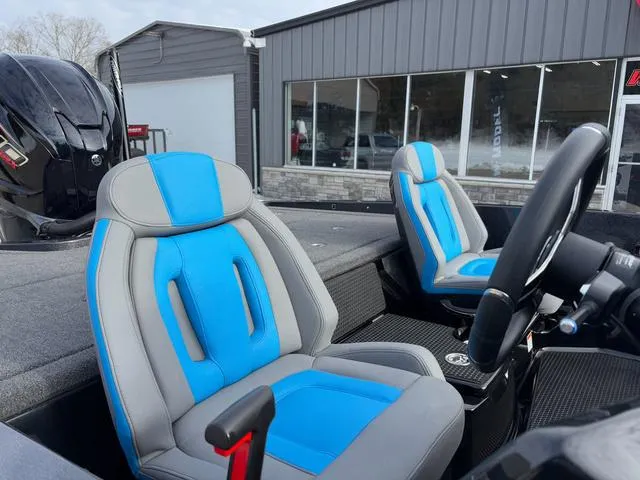 Slide: The Image of 2025 iKon LX20 boat interior with blue and gray seats, steering wheel, and motor. - 10
