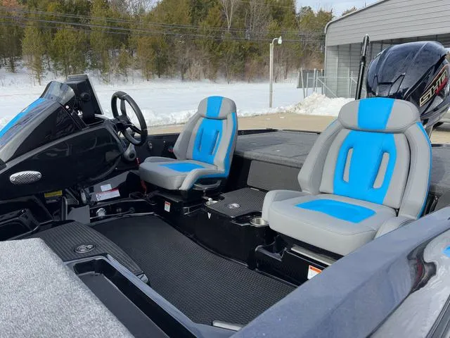 Slide: The Image of 2025 iKon LX20 boat interior with blue and gray seats, steering wheel, and dashboard. - 18