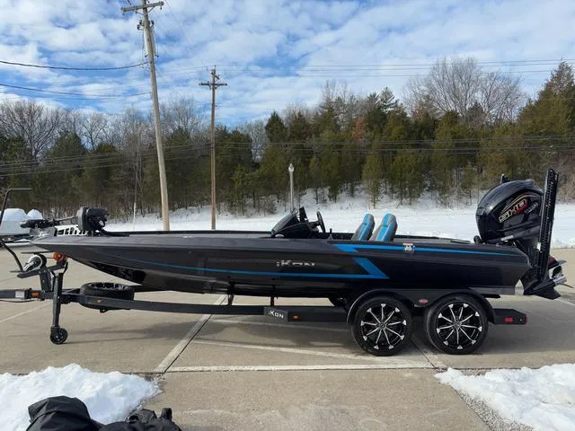 Slide: The Image of 2025 iKon LX20 boat on trailer, parked outdoors in snowy setting. - 21