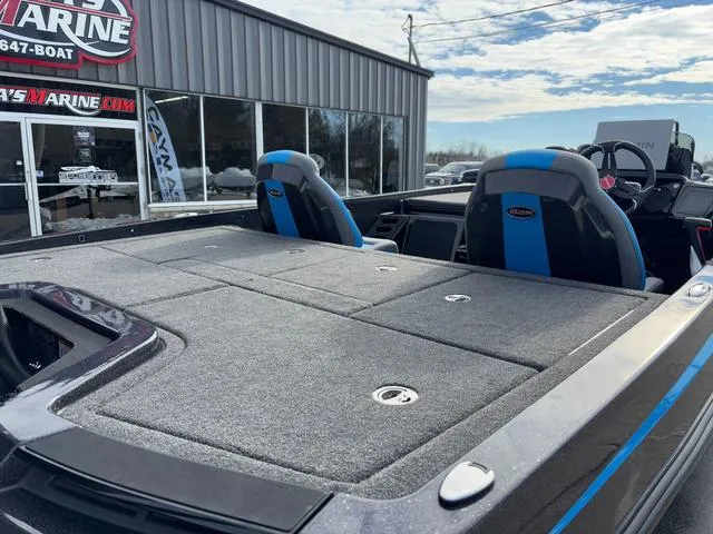 Slide: The Image of 2025 iKon LX20 boat with blue seats at a marine dealership. - 7