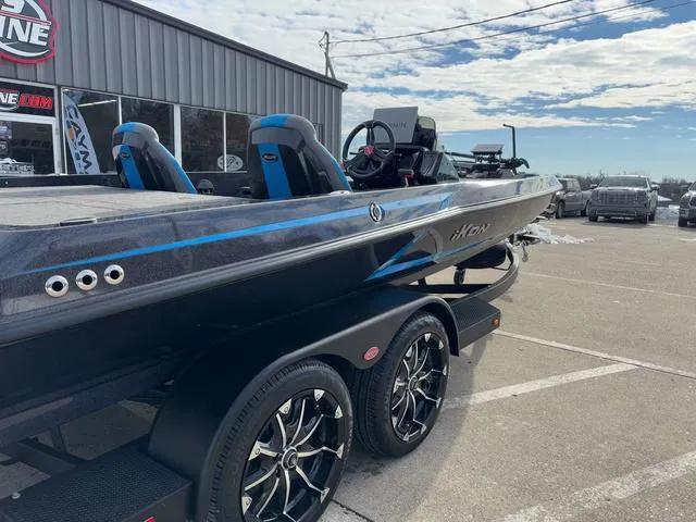 Slide: The Image of 2025 iKon LX20 boat on trailer, parked outside dealership under cloudy sky. - 8