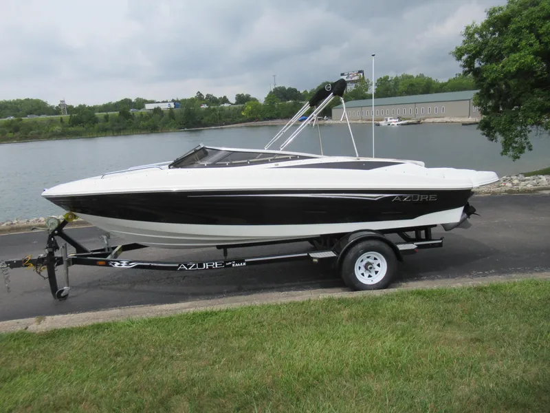 Slide: The Image of 2009 Azure AZ208 boat on trailer by a lake, overcast sky. - 10