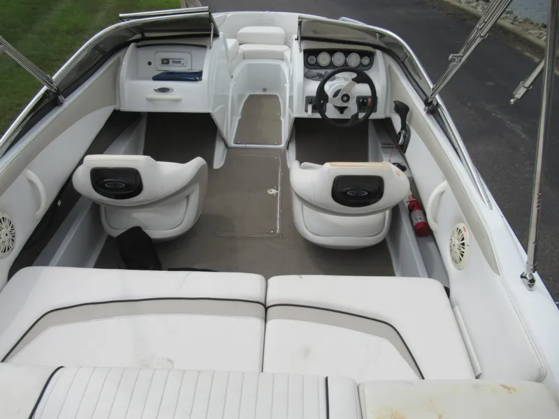 Slide: The Image of Interior of a 2009 Azure AZ208 boat with white seating and dashboard. - 11