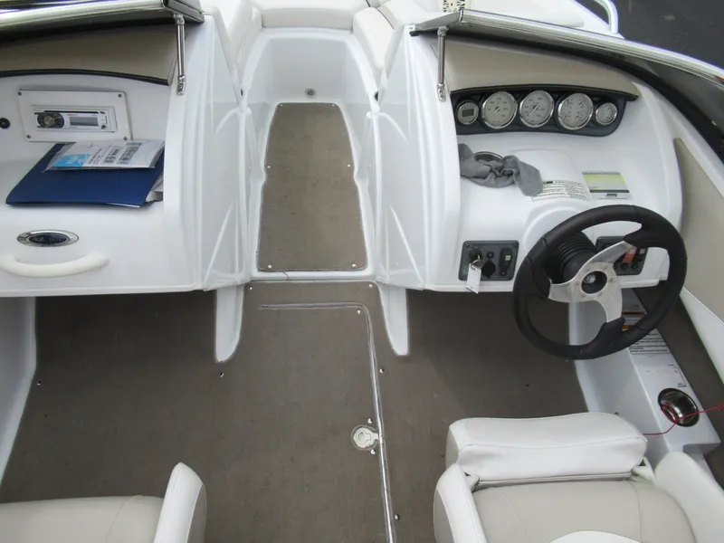 Slide: The Image of Interior of a 2009 Azure AZ208 boat, featuring steering wheel and dashboard controls. - 12