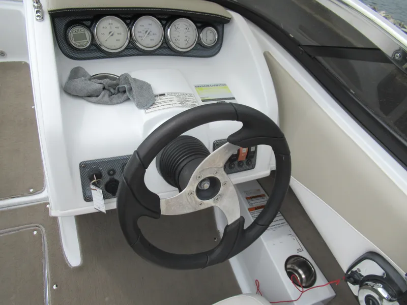 Slide: The Image of Steering wheel and dashboard of 2009 Azure AZ208 boat with gauges and controls. - 13