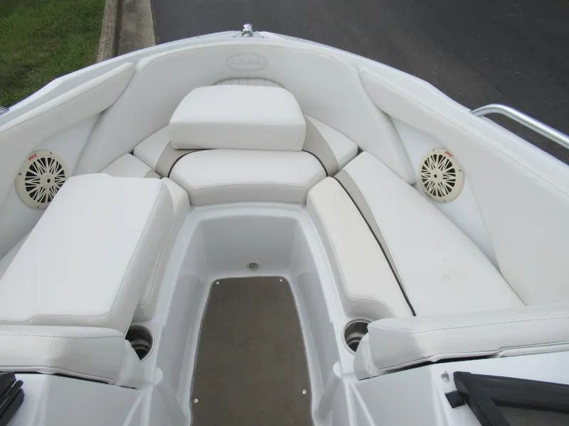 Slide: The Image of 2009 Azure AZ208 boat interior with white cushioned seating and built-in speakers. - 17