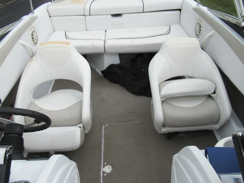 Slide: The Image of Interior of a 2009 Azure AZ208 boat with white seating and steering wheel. - 20