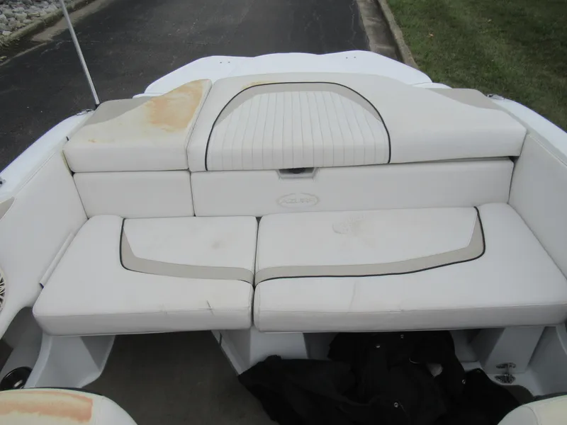 Slide: The Image of 2009 Azure AZ208 boat interior with white cushioned seating, showing slight wear. - 21