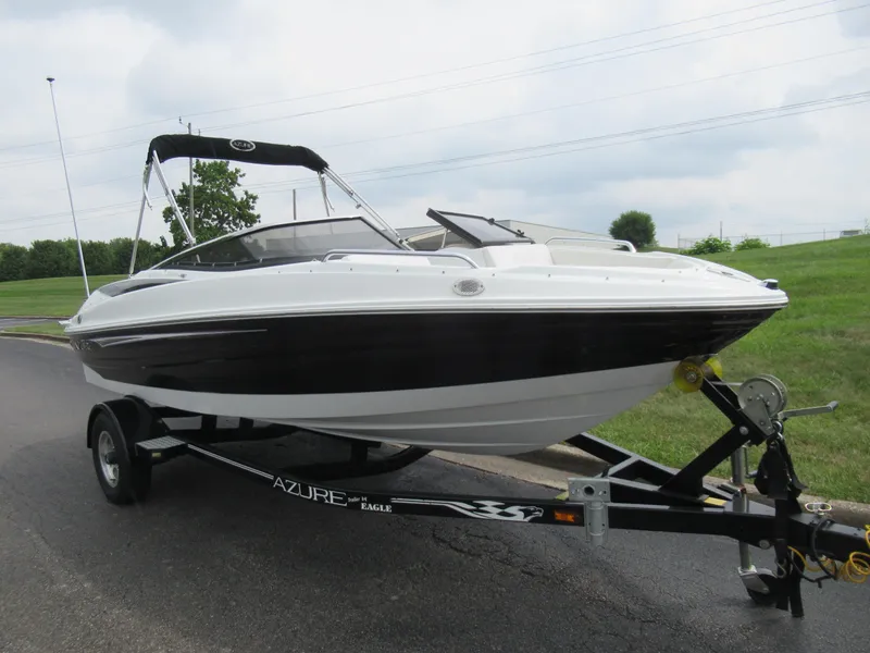 Slide: The Image of 2009 Azure AZ208 boat on trailer, black and white design, parked on road. - 5