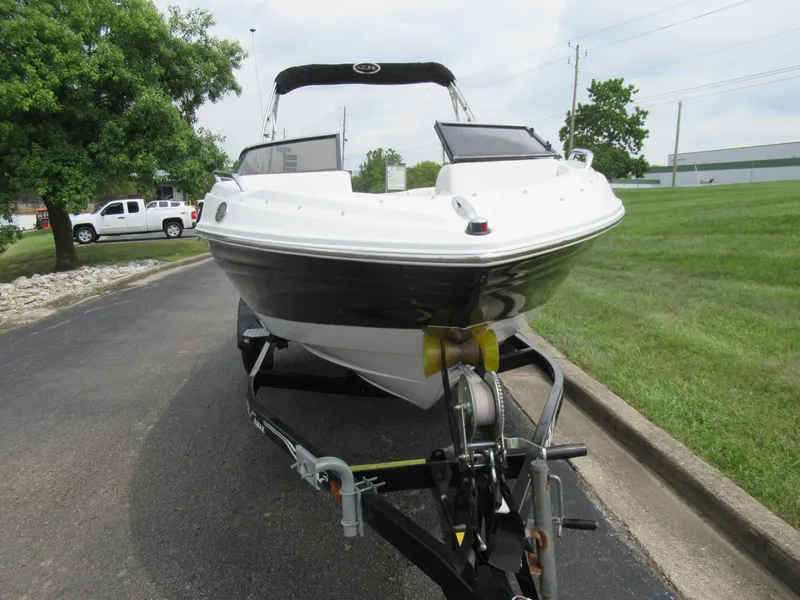 Slide: The Image of 2009 Azure AZ208 boat on trailer, parked on a paved road near grassy area. - 6