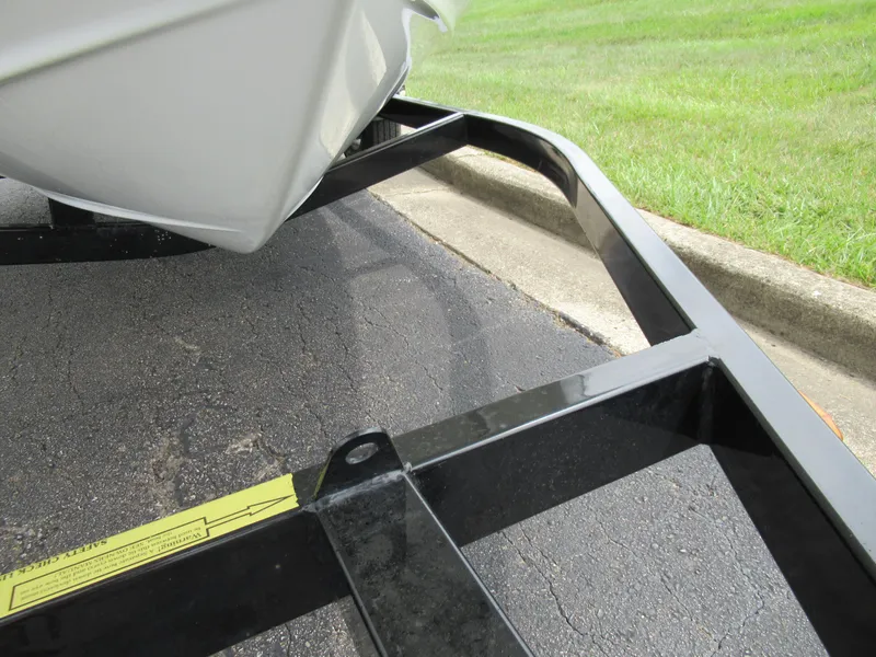 Slide: The Image of Boat trailer frame for 2009 Azure AZ208 on pavement near grass. - 7